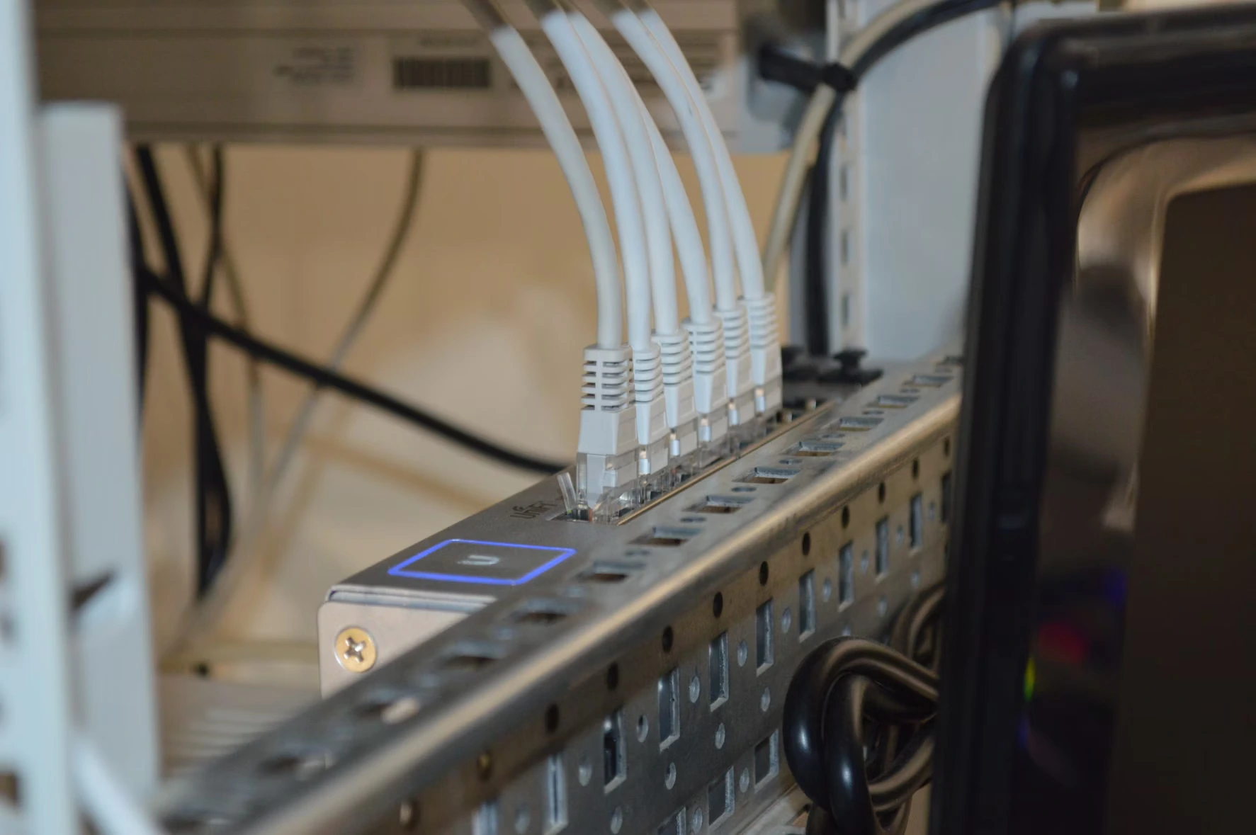 Close-up shot of a server with a number of ethernet cables coming out of it